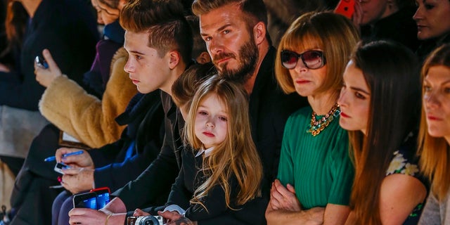 David Beckham with daughter, Harper, at New York Fashion Week event. (Reuters)