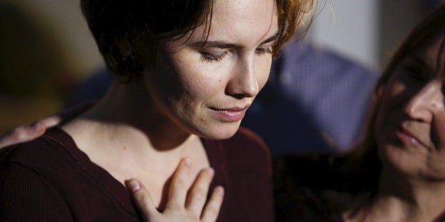 March 27, 2015: Amanda Knox talks to the press surrounded by family outside her mother's home in Seattle, Washington.