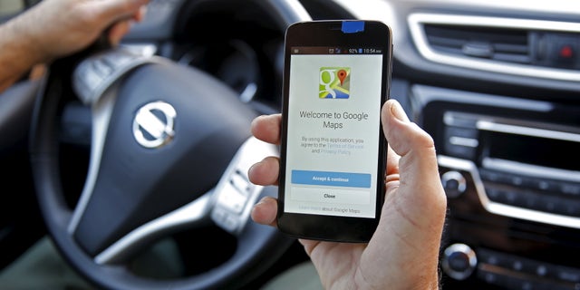 A man holds a smartphone, with the Google Maps app open, in Sarajevo, April 15, 2015. (REUTERS/Dado Ruvic)
