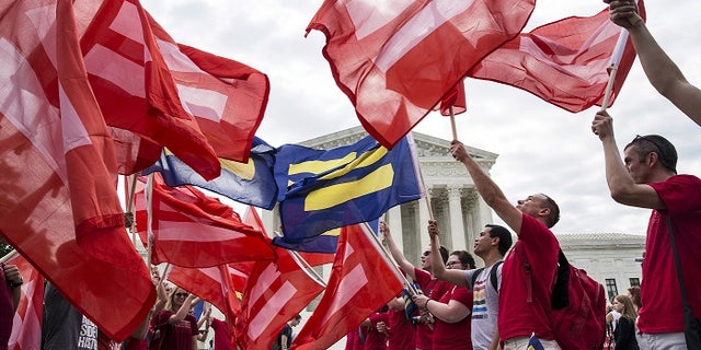 Supporters of gay marriage rally in front of the Supreme Court ahead of its landmark decision to legalize it nationwide.
