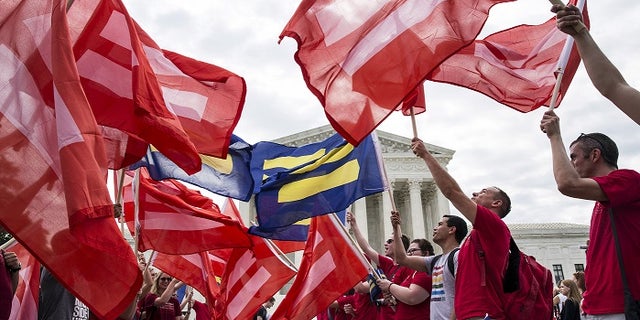 Supporters of gay marriage rally in front of the Supreme Court ahead of its landmark decision to legalize it nationwide.