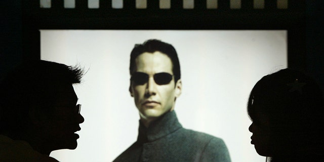 Chinese movie patrons wait in front of Hollywood star Keanu Reeves
poster in the movie Matrix Reloaded showing at Paradise Warner Bros
Cinema City in Shanghai July 18, 2003. Four of the world's biggest film
studios - Walt Disney Co, AOL Time Warner's Warner Bros, Vivendi
Universal and News Corp's Twentieth Century Fox - have taken their
first open legal action against video pirates in China, an attorney
representing the group said. The group estimated that 90 percent of
foreign motion picture materials sold in China are pirated.
REUTERS/Claro Cortes IV
CC/DL - RP4DRHYPSJAB