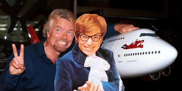 Virgin Atlantic Airways CEO Richard Branson (L) poses with a cut-out of actor Mike Myers, as Austin Powers, after christening ceremonies of Virgin Shaglantic Flight double-O-Seven at Los Angeles International Airport, May 10. The unveiling of the renamed and redecorated airliner signaled the start of a dynamic global air travel marketing blitz in the partnership with the release of the New Line Cinema movie "Austin Powers: The Spy Who Shagged Me".