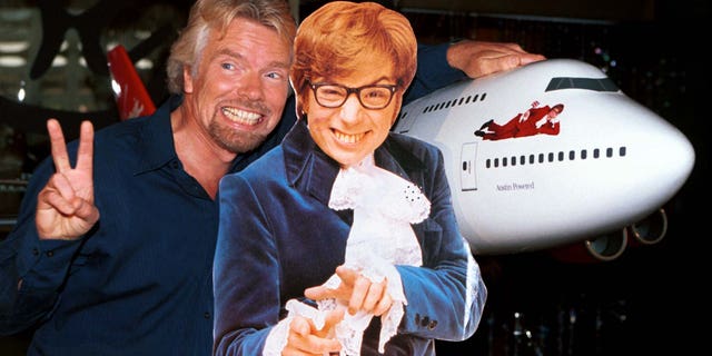 Virgin Atlantic Airways CEO Richard Branson (L) poses with a cut-out of actor Mike Myers, as Austin Powers, after christening ceremonies of Virgin Shaglantic Flight double-O-Seven at Los Angeles International Airport, May 10. The unveiling of the renamed and redecorated airliner signaled the start of a dynamic global air travel marketing blitz in the partnership with the release of the New Line Cinema movie "Austin Powers: The Spy Who Shagged Me".