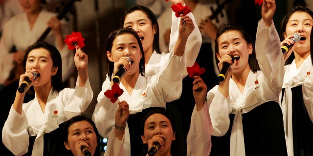 Members of the North Korean cheering squad in traditional costume sing during a cultural performance in Incheon. (Reuters)