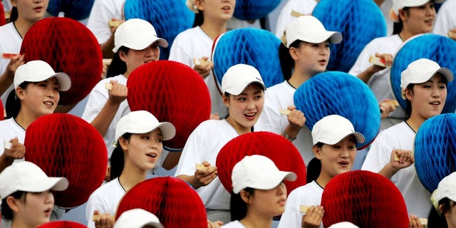 North Korea often sends a brigade of women to sporting events to cheer on the athletes.