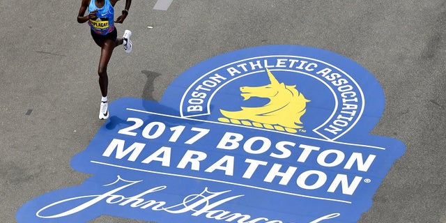 Edna Kiplagat, of Kenya, runs down Boylston Street towards the Boston Marathon finish line. She took first place in the women's division in 2017.