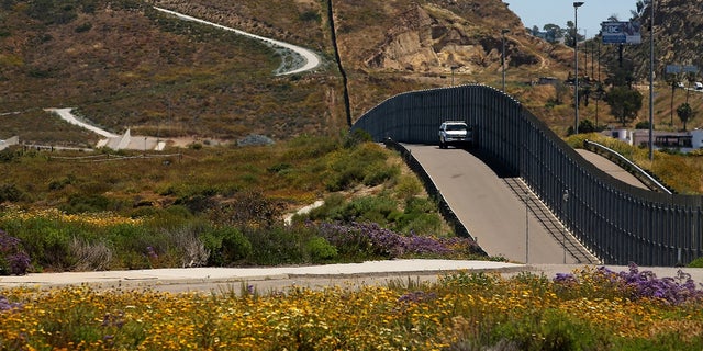 U.S. Border Patrol Agents man the fence between the U.S. and Mexico in San Diego, Calif.