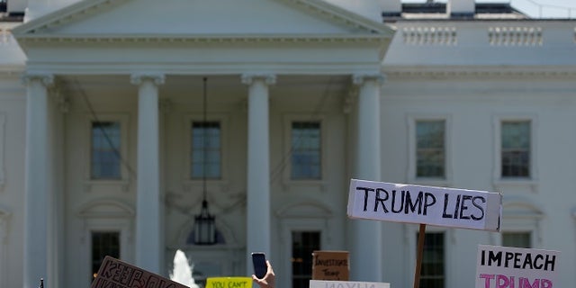 Protesters gather to rally against U.S. President Donald Trump's firing of Federal Bureau of Investigation (FBI) Director James Comey, outside the White House in Washington, U.S. May 10, 2017.