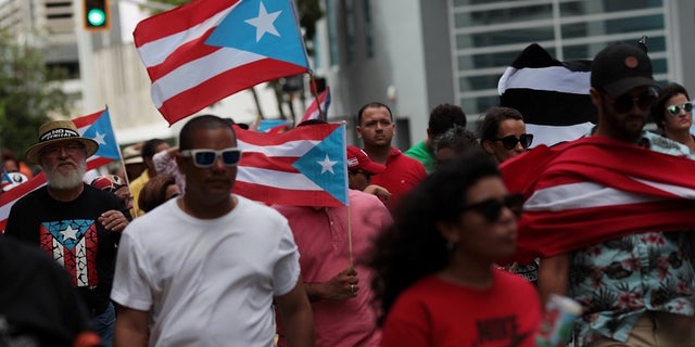 People march in support of Puerto Rico becoming an independent nation as the economically struggling U.S. island territory voted overwhelmingly on Sunday in favour of becoming the 51st state, in San Juan, Puerto Rico June 11, 2017. REUTERS/Alvin Baez - RTS16MR0