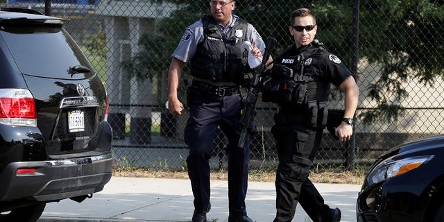 Police investigate a shooting scene after a gunman opened fire on Republican members of Congress during a baseball practice near Washington in Alexandria, Virginia, June 14, 2017. REUTERS/Joshua Roberts - RTS17201