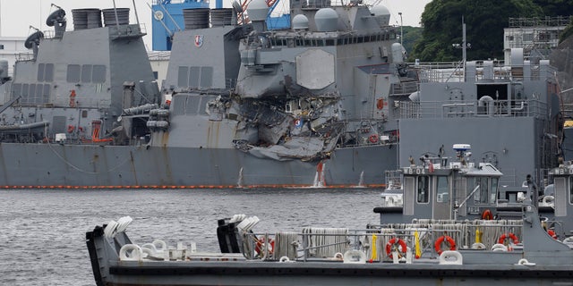 The Arleigh Burke-class guided-missile destroyer USS Fitzgerald, damaged by colliding with a Philippine-flagged merchant vessel, is seen at the U.S. naval base in Yokosuka, Japan.
