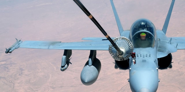 A F-18 Super Hornet receives fuel.