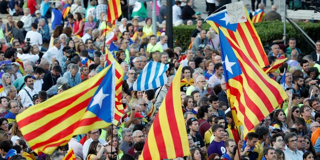 People hold Esteladas (Catalan separatist flags) as they wait for a closing rally in favour of the banned October 1 independence referendum in Barcelona, Spain September 29, 2017.