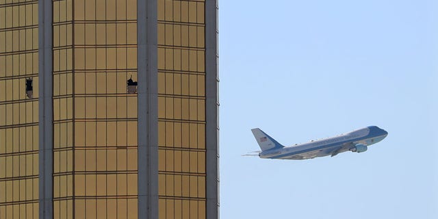 Air Force One departs Las Vegas past the broken windows on the Mandalay Bay hotel, where shooter Stephen Paddock conducted his mass shooting along the Las Vegas Strip in Las Vegas, Nevada.