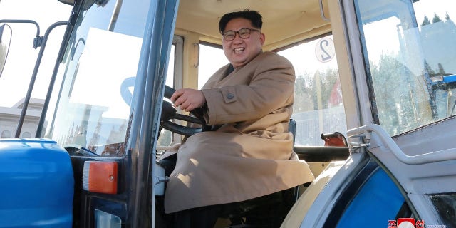 Kim is pictured in a tractor during a field guidance visit.