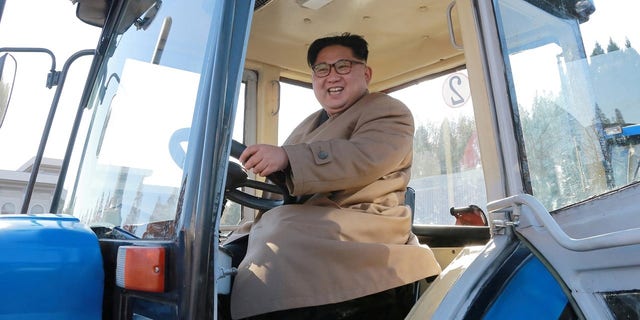 Kim is pictured in a tractor during a field guidance visit.