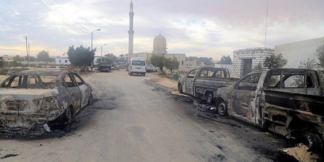 Damaged vehicles are seen after a bomb exploded at Al Rawdah mosque in Bir Al-Abed, Egypt