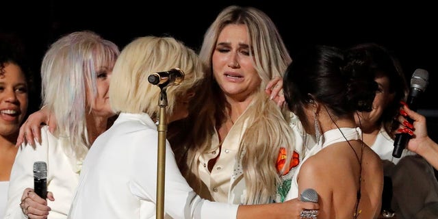 The performance ended with a group up and many of the singers, including Kesha, in tears.