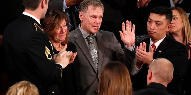 Fred and Cindy Warmbier cry as U.S. President Donald Trump talks about the death of their son Otto after his arrest in North Korea during the State of the Union address to a joint session of the U.S. Congress on Capitol Hill.