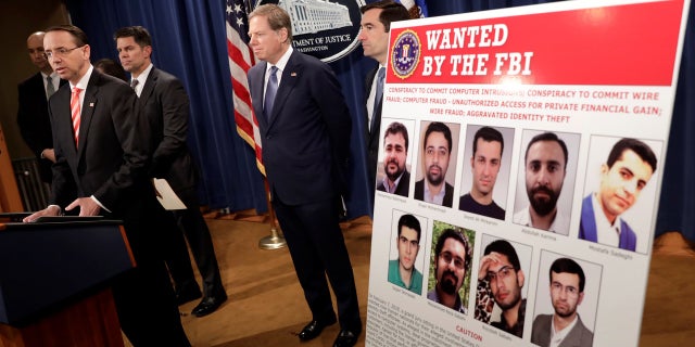 U.S. Deputy Attorney General Rod Rosenstein speaks at a news conference with other law enforcement officials at the Justice Department to announce nine Iranians charged with conducting massive cyber theft campaign, in Washington, U.S., March 23, 2018.
