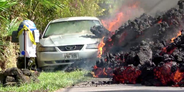 Lava engulfs a Ford Mustang in Puna, Hawaii, over the weekend.