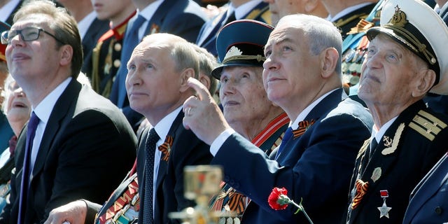Putin and Netanyahu watch the Victory Day parade.