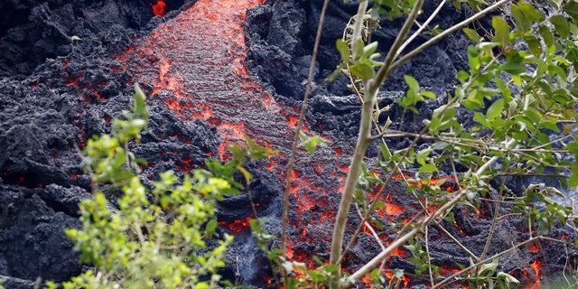 In this May 12, 2018 photo, lava erupts from a fissure during ongoing eruptions of the Kilauea Volcano in Hawaii.