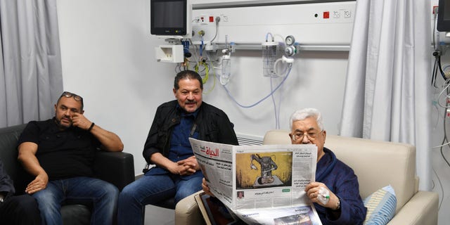 Palestinian President Mahmoud Abbas reads a newspaper inside the hospital in Ramallah, in the occupied West Bank May 21, 2018.