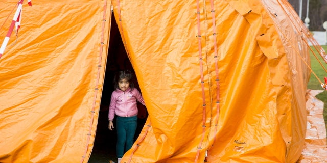 Oct. 13, 2015: A girl looks out from a temporary reception centre at Storskog border station in northern Norway. (Reuters).