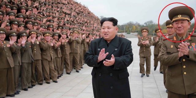 Kim Jong Un, left, greeting officials with Hwang Pyong-so by his side in 2015.