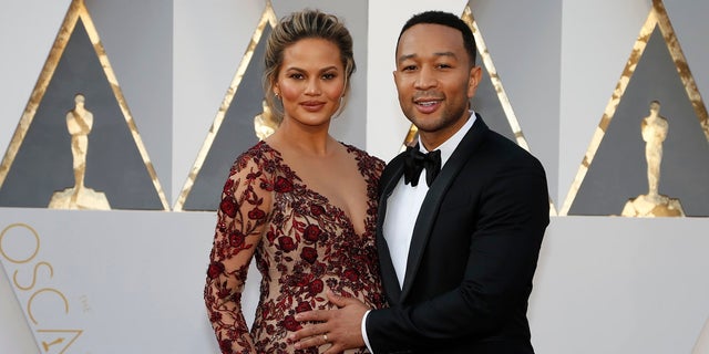 Model Chrissy Teigen and singer John Legend arrive at the 88th Academy Awards in Hollywood, Calif., Feb. 28, 2016. The couple welcomed a baby boy Wednesday.