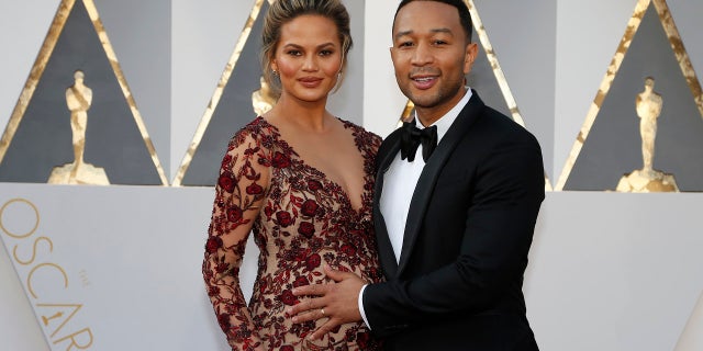 Model Chrissy Teigen and singer John Legend arrive at the 88th Academy Awards in Hollywood, Calif., Feb. 28, 2016. The couple welcomed a baby boy Wednesday.