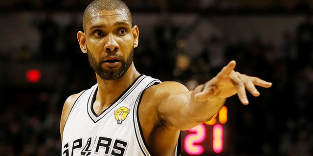 San Antonio Spurs' Tim Duncan points to the bench during a break in play against the Miami Heat in the second half during Game 3 of their NBA Finals basketball playoff in San Antonio, Texas June 11, 2013. REUTERS/Lucy Nicholson/File Photo - S1AETPGNVHAB