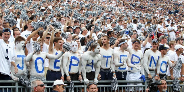 Students honoring Paterno cheer during the game.