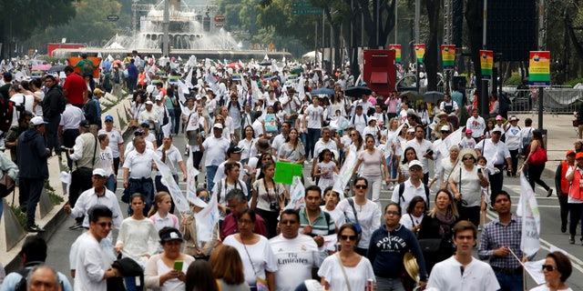 Protesters arriving to march against the legalization of gay marriage, near the Angel of Independence monument in Mexico City.
