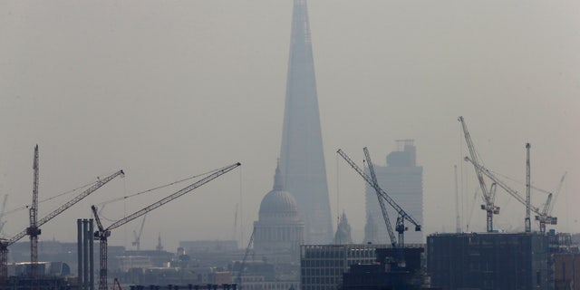 Smog surrounds The Shard and St Paul's Cathedral in London, Britain, April 3, 2014.