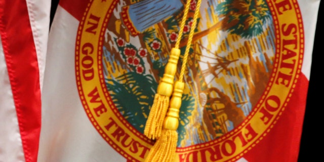 The Florida state flag displays "In God We Trust" on the seal. A state lawmaker proposed a bill that would end the state's Democratic Party.