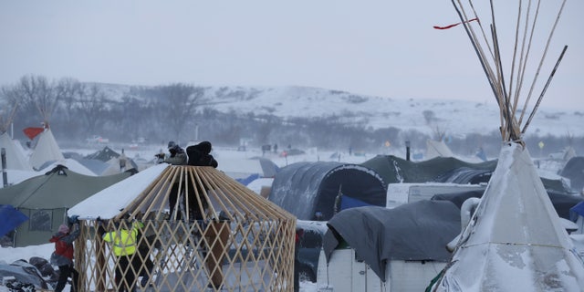 Activists build a shelter near Cannon Ball, N.D., on Monday.