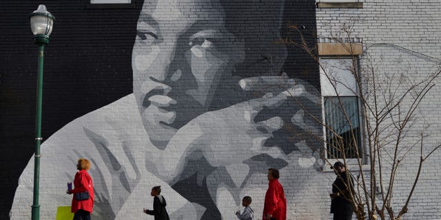 FILE -- People gather to march in the annual parade down MLK Boulevard to honor Martin Luther King.