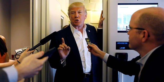 U.S. President Donald Trump speaks with reporters aboard Air Force One on his way to a "Make America Great Again" rally at Orlando Melbourne International Airport in Melbourne, Florida, U.S. February 18, 2017.