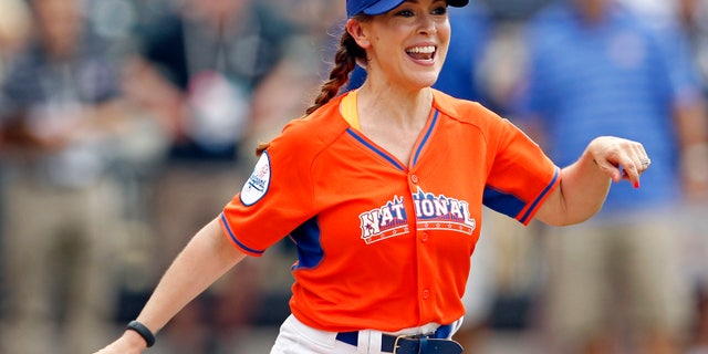 Actress Alyssa Milano reacts as she runs up the first baseline during the Legends and Celebrities All-Star softball game at Citi Field in New York, July 14, 2013. The 2013 Major League Baseball's All-Star Game will be played at Citi Field on Tuesday. REUTERS/Adam Hunger (UNITED STATES - Tags: SPORT BASEBALL ENTERTAINMENT SOFTBALL) - RTX11MXT