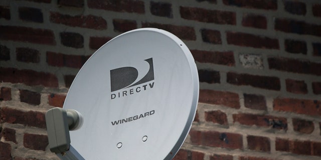A DirecTV dish is seen outside a home in the Queens borough of New York July 29, 2013.