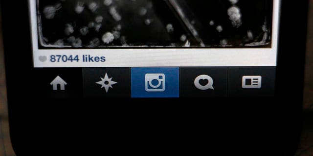 The number of likes on an Instagram photo are pictured on a mobile device screen in Pasadena, California August 14, 2013. Researchers with RSA security have learned that Zbot, one of the world's biggest botnets is creating fake Instagram accounts and selling bundled followers and "likes" at rates that are much higher than what it charges for credit card numbers.  REUTERS/Mario Anzuoni  (UNITED STATES - Tags: ENTERTAINMENT) - RTX12MB1