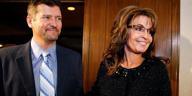 Former Alaska Gov. Sarah Palin and husband Todd Palin arrive for a celebration for evangelist Billy Graham's 95th birthday, in Asheville, N.C., Nov. 8, 2013.