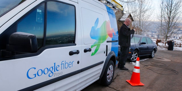 File photo: A technician gets cabling out of his truck to install Google Fiber in a residential home in Provo, Utah, January 2, 2014.