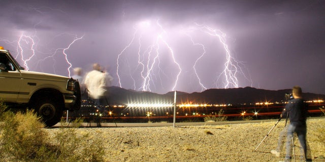 File photo: Southern California storm chasing photographers take pictures of the mass lightning bolts lighting up night skies from monsoon storms passing over the high deserts, early Wednesday north of Barstow, California, July 1, 2015. Picture taken using long exposure. (REUTERS/Gene Blevins)