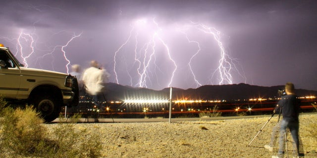 File photo: Southern California storm chasing photographers take pictures of the mass lightning bolts lighting up night skies from monsoon storms passing over the high deserts, early Wednesday north of Barstow, California, July 1, 2015. Picture taken using long exposure. (REUTERS/Gene Blevins)