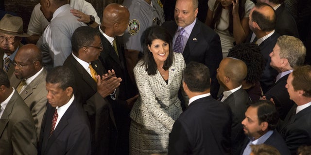South Carolina Gov. Nikki Haley is greeted at the state house before she signed legislation removing the Confederate battle flag from the state Capitol grounds.
