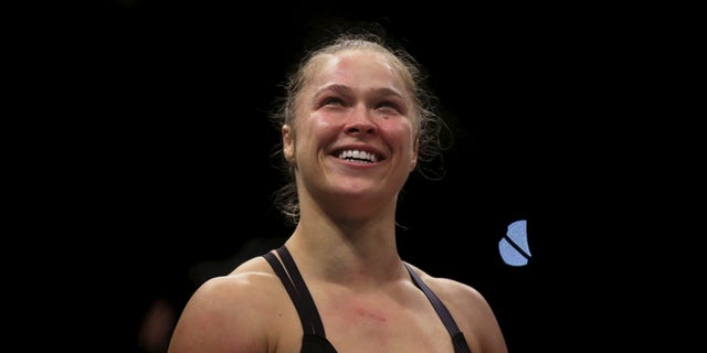Ronda Rousey (R) of U.S celebrates after defeating Bethe Correia of Brazil during their Ultimate Fighting Championship (UFC) match, a professional mixed martial arts (MMA) competition in Rio de Janeiro, Brazil August 1, 2015.